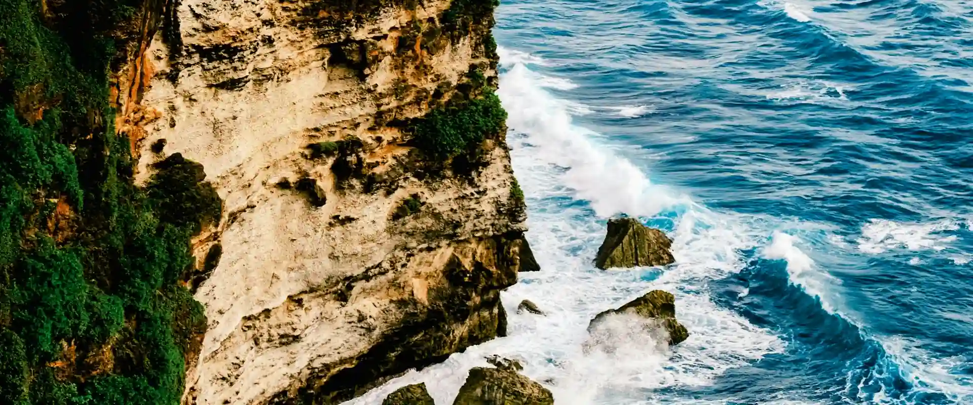 Limestone cliffs dropping into the ocean at Uluwatu, Bali